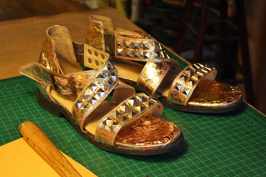 a pair of custom gold sandals