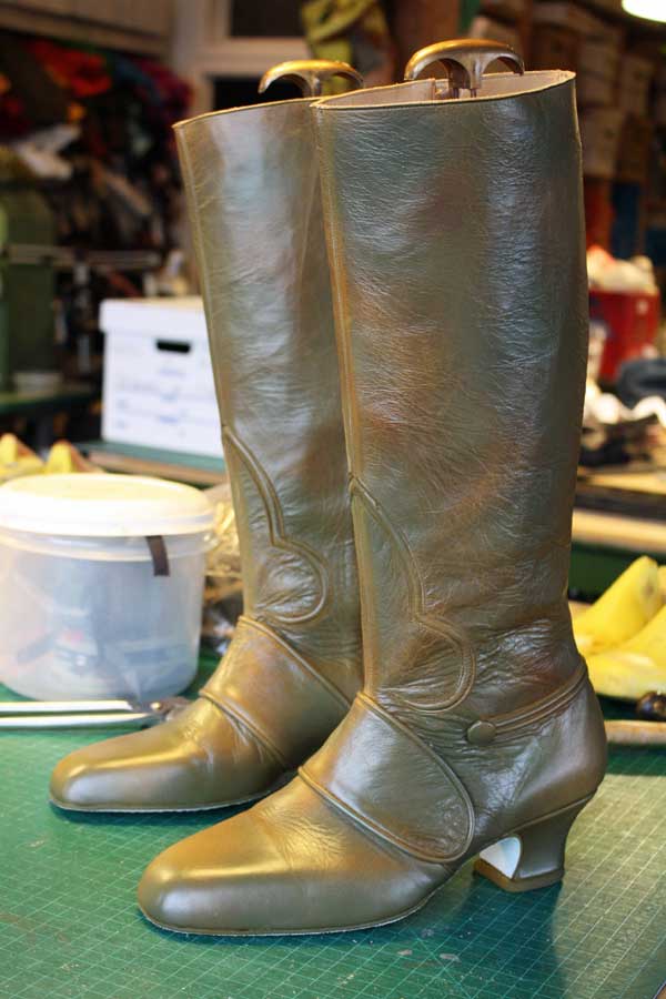 a pair of custom olive leather heeled boots
