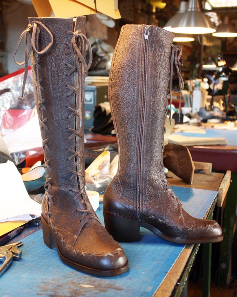 a pair of custom brown leather stitched boots