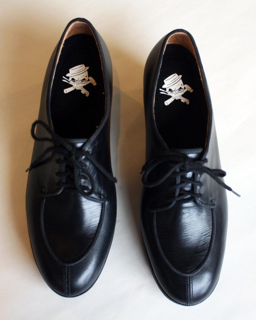 a pair of custom black dress shoes