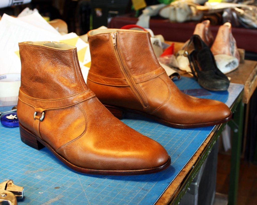 a pair of custom brown leather ankle boots