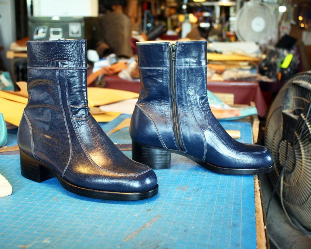 a pair of custom blue leather ankle boots