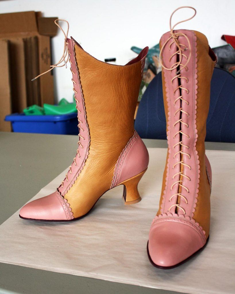 a pair of custom pink and brown leather high heeled boots