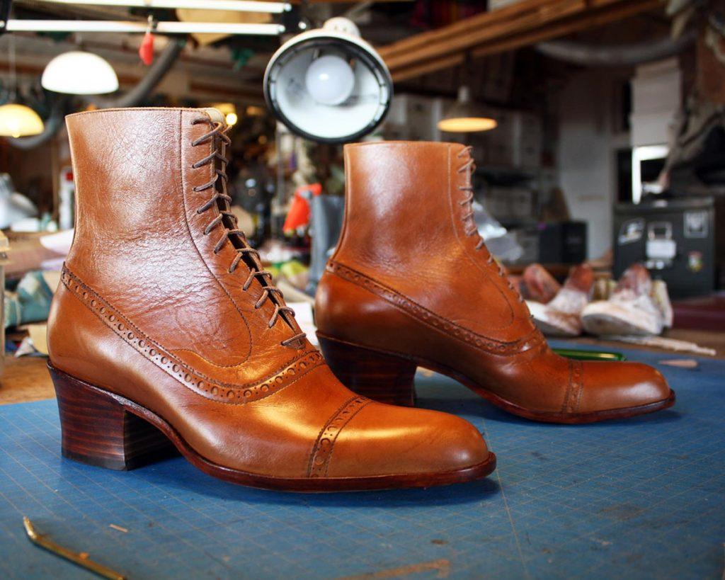 a pair of custom brown leather heeled ankle boots