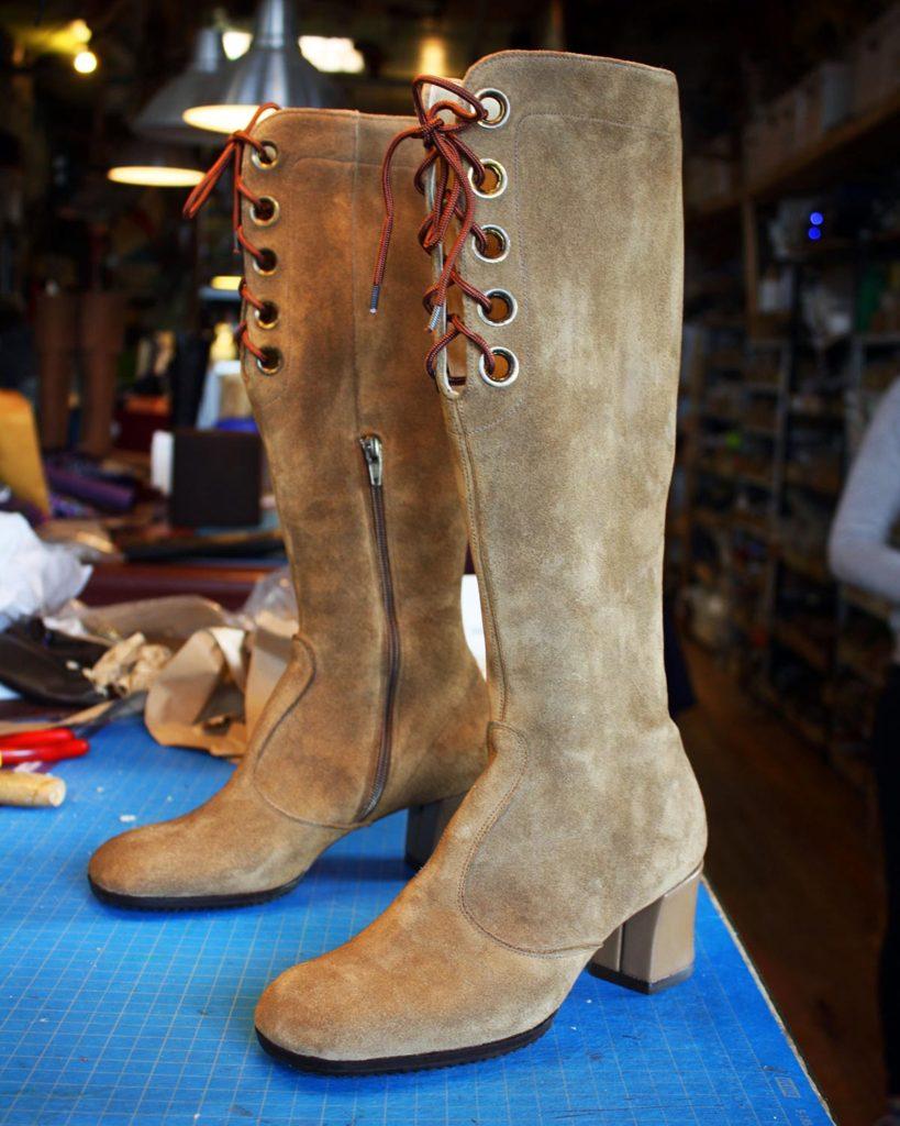 a pair of custom tan suede boots