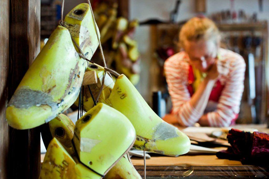 Yellow shoe dummy with a lady in background