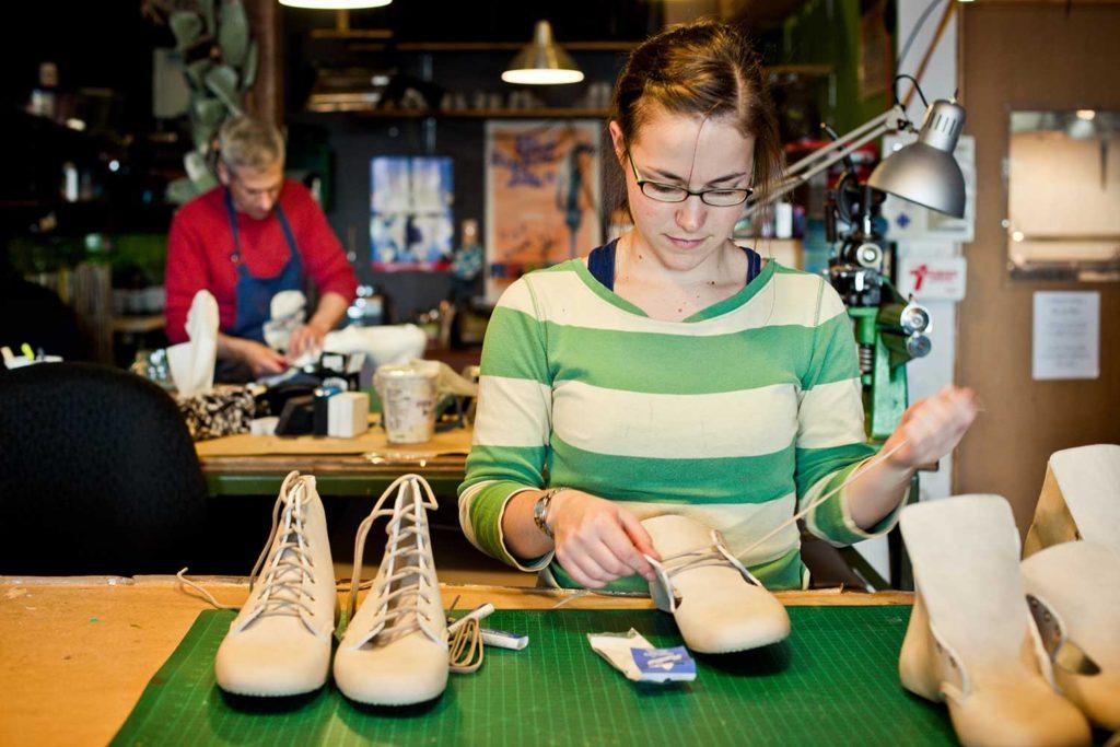 lady lacing the shoes in warehouse
