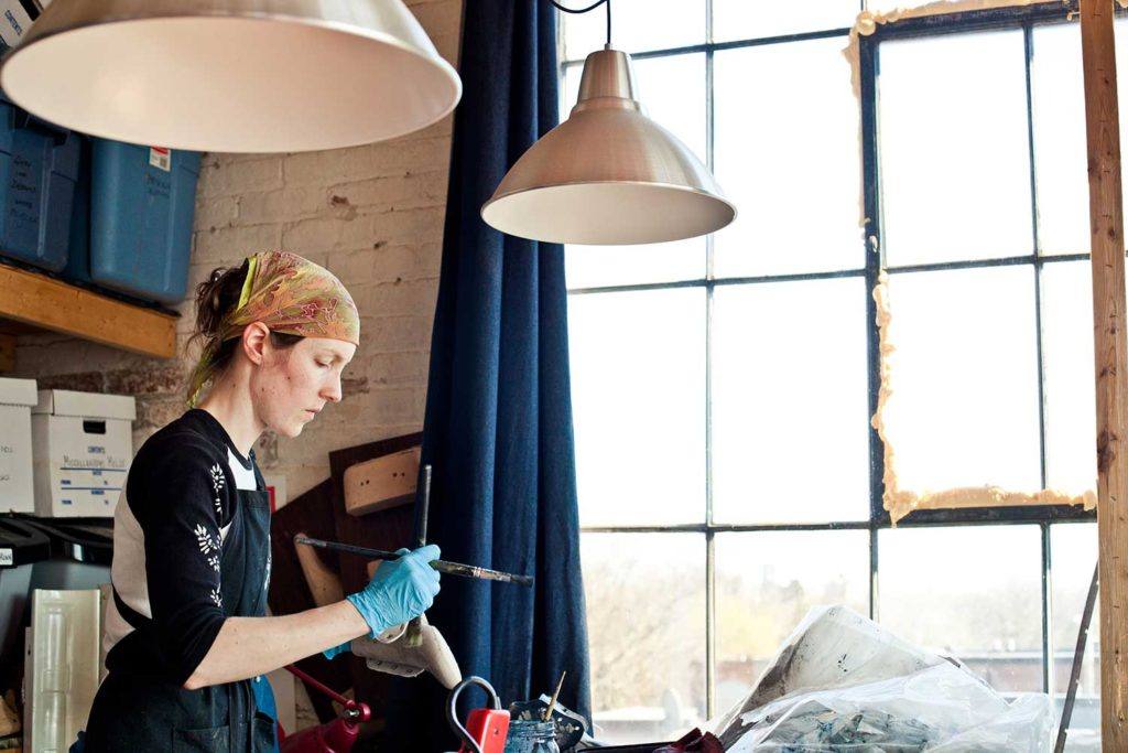 lady coloring the shoe in warehouse