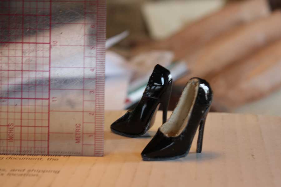 a pair of black miniature high heels