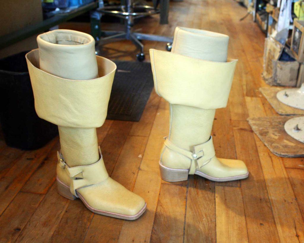 a pair of custom white leather period theatre boots