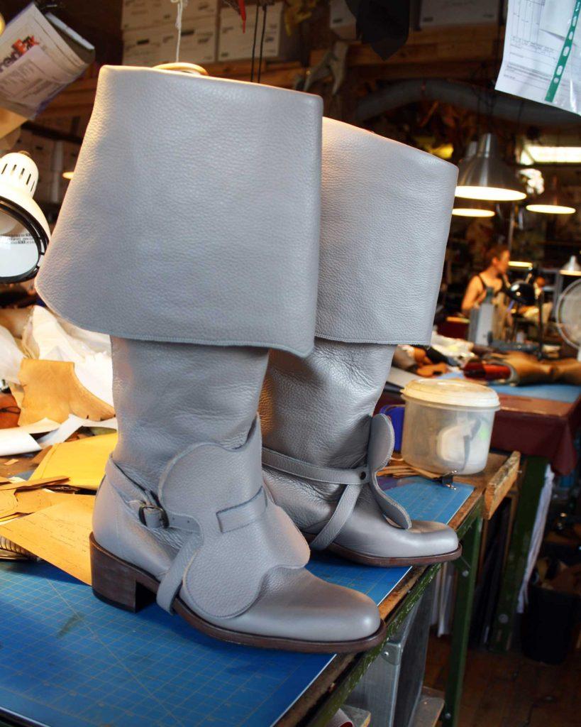 a pair of custom grey leather period theatre boots