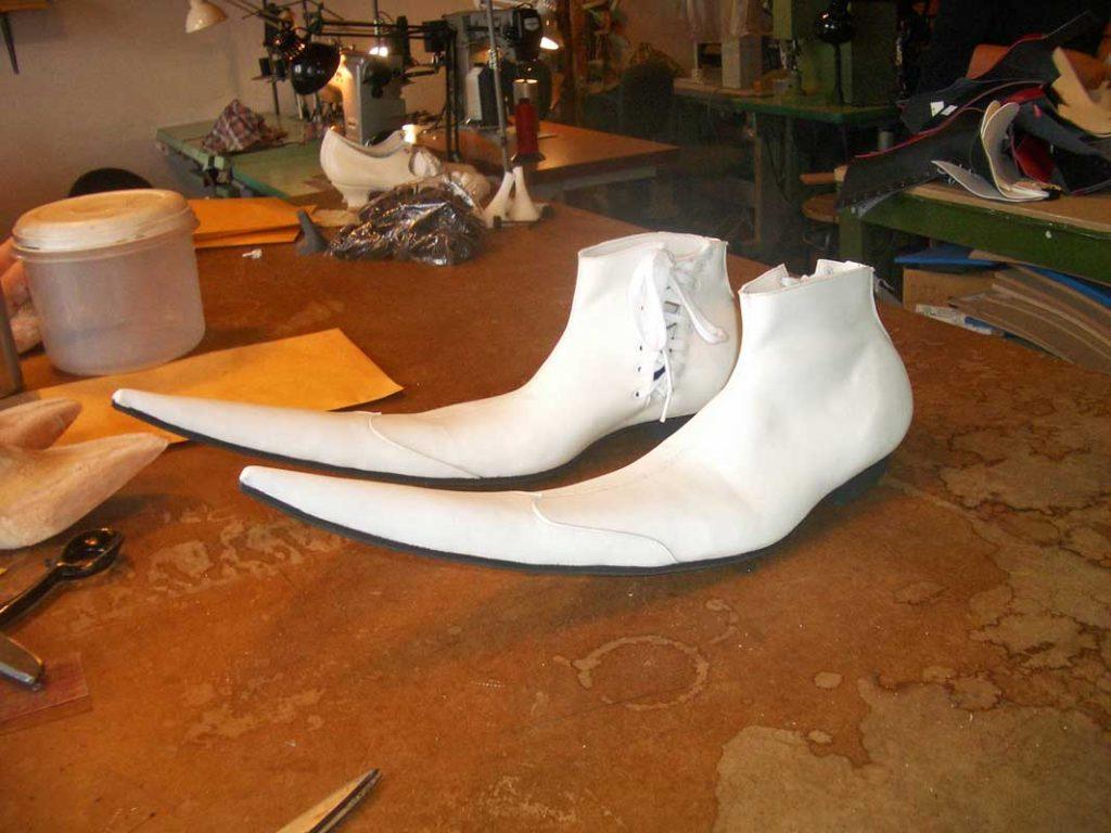 Pair of long pointed white leather shoes
