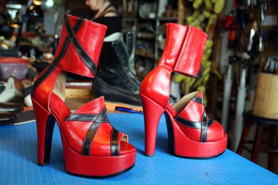 pair of red high heel sandals with black stripes