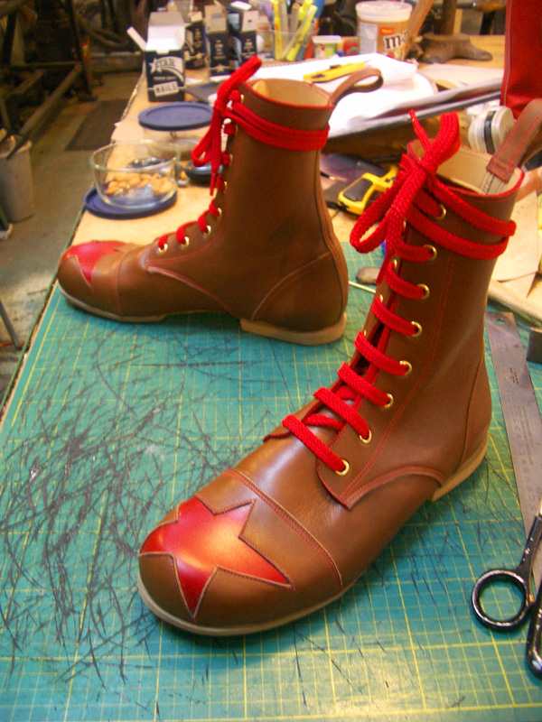 pair of brown boots with red star and red lace