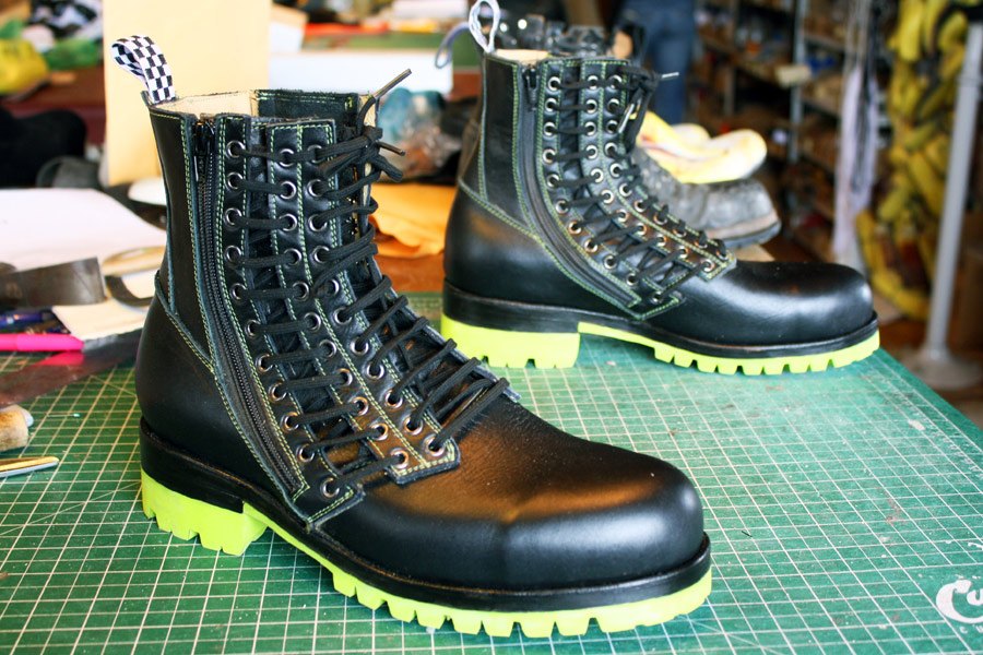 black triple lace boots with green soles