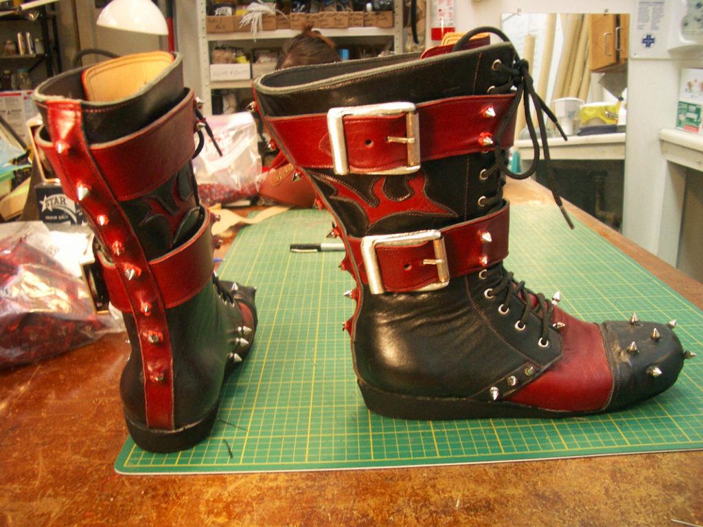 black and red boots covered in spikes