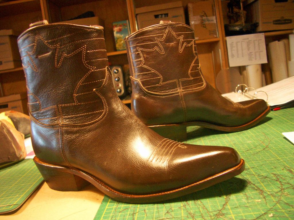 brown ankle boots with maple leaf engraved
