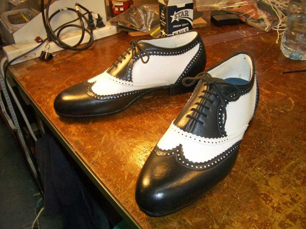 pair of black and white leather shoes with lace