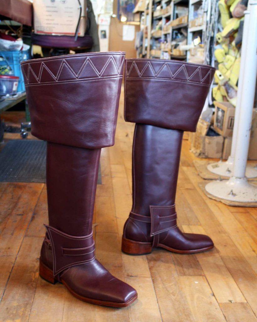 pair of dark brown period boots with straps
