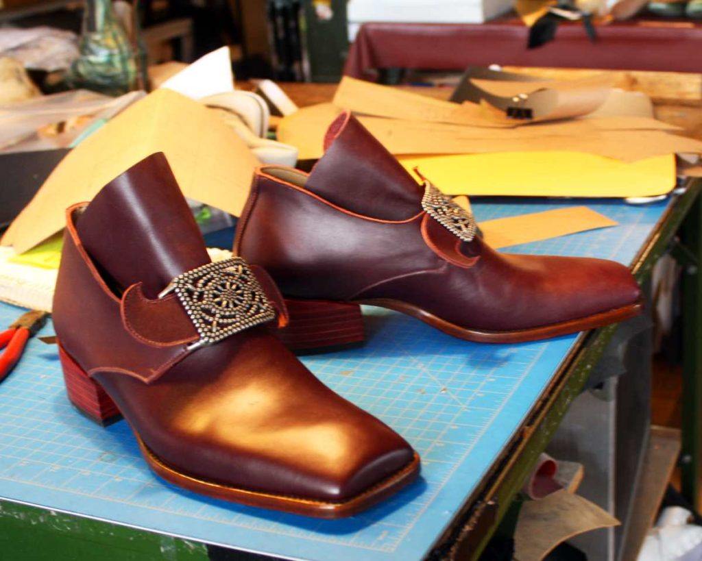 pair of dark brown shoes with heels and buckle