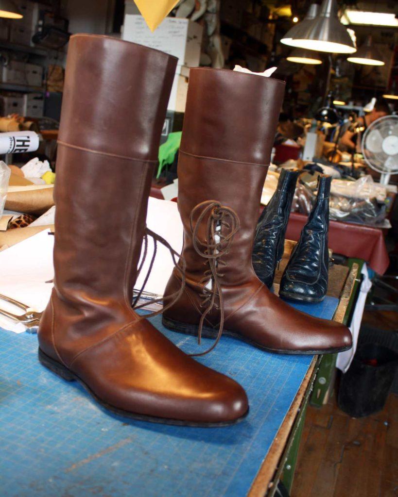 a pair of custom brown boots with side lacing