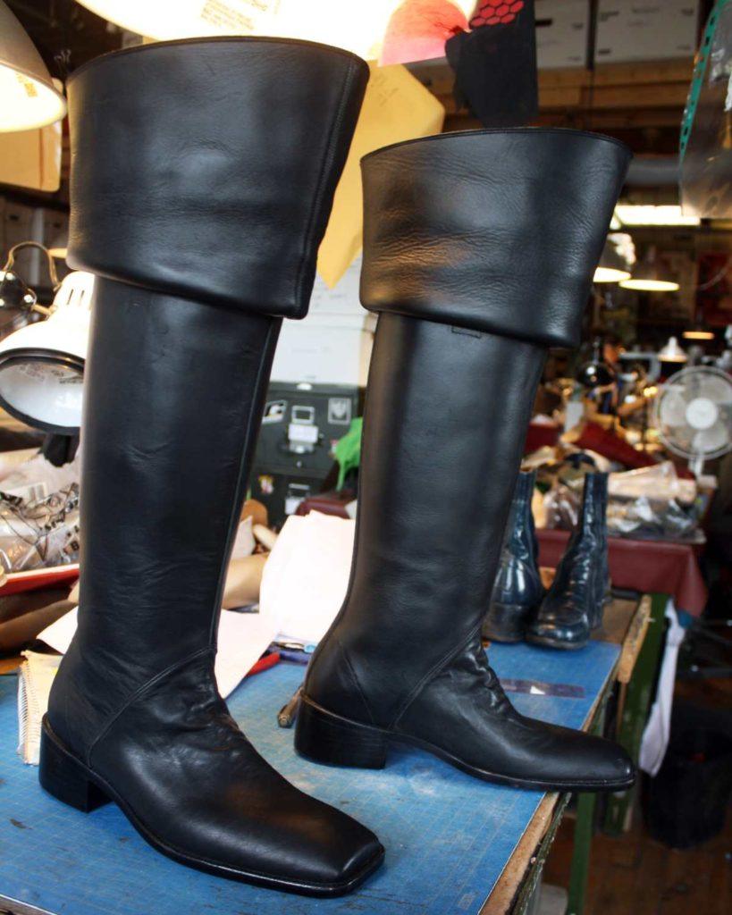 a pair of custom black period theater boots