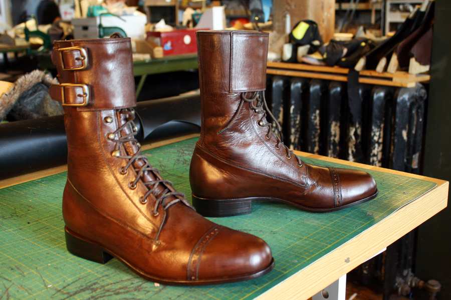 pair of brown leather boots with straps