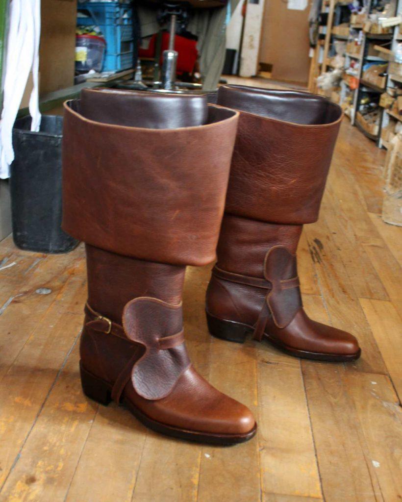 Pair of brow period boots with straps