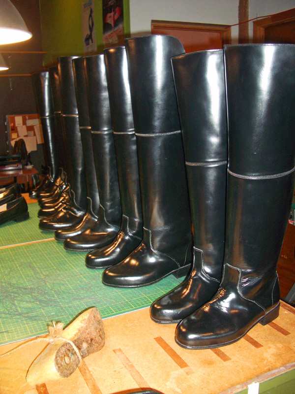 sets of thigh length boots in a row