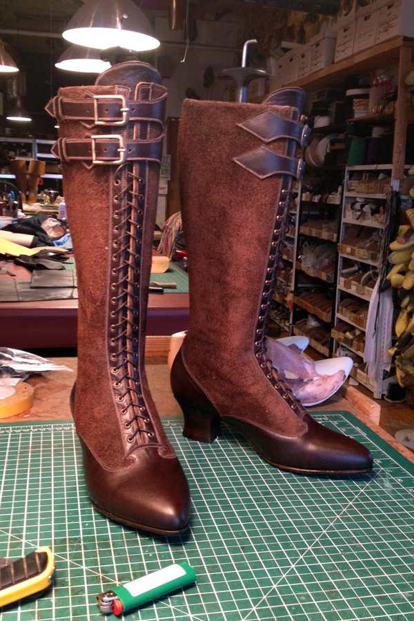 brown leather knee length boots with laces and buckles