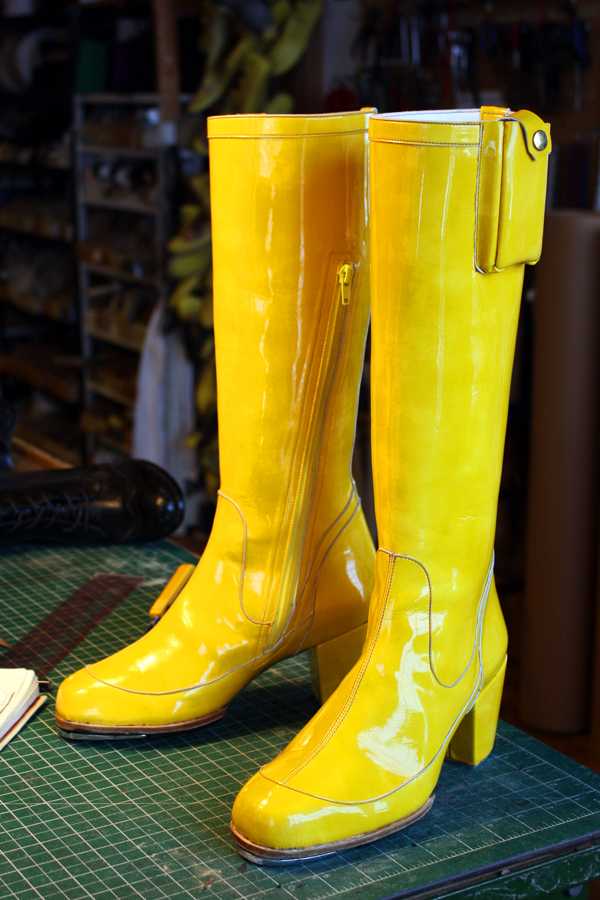 a pair of yellow long boots with lace up