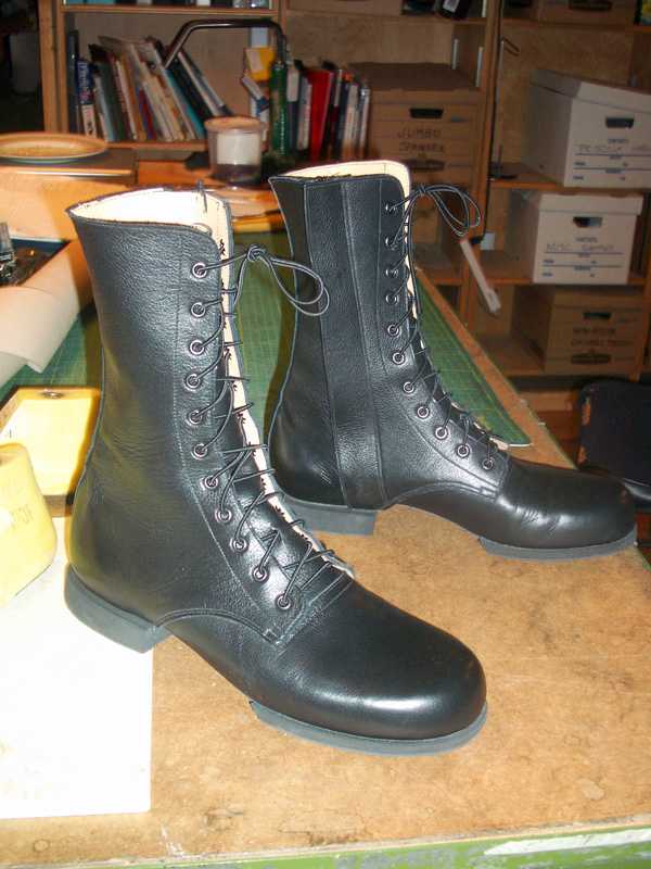 a pair of black leather shoes boots with lace up