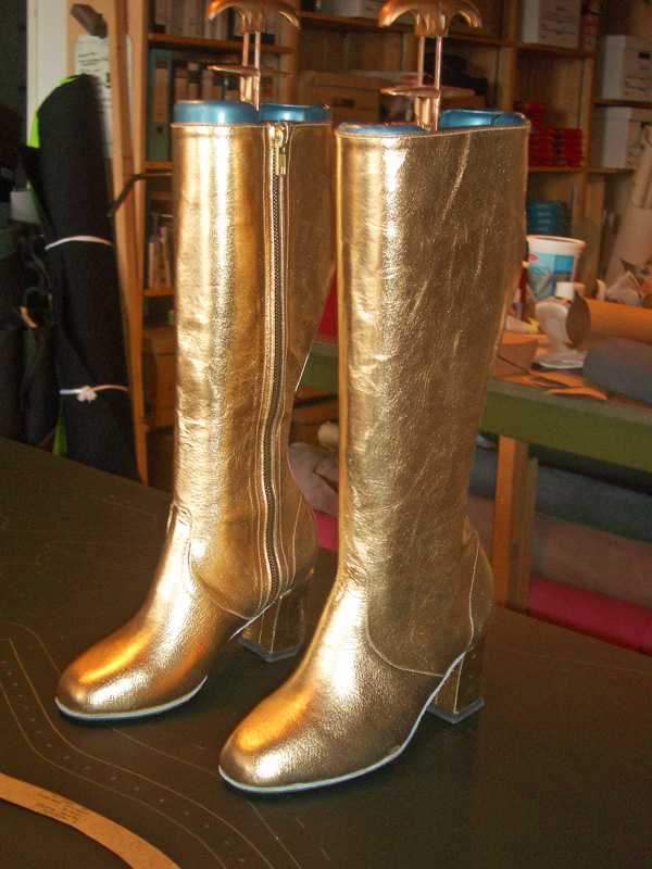 Pair of Golden long boots with heels