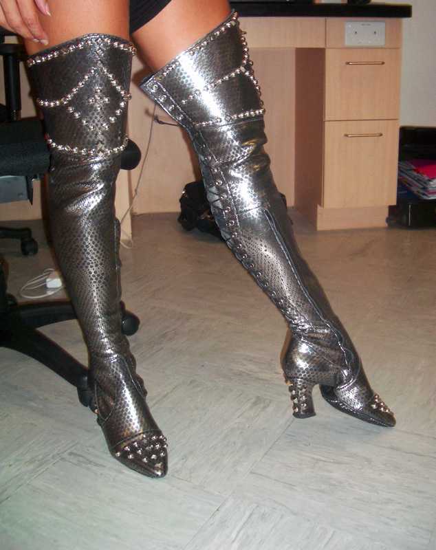 pair of black long boots with studs and spikes