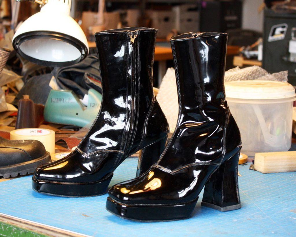 a pair of shining black high heel boots