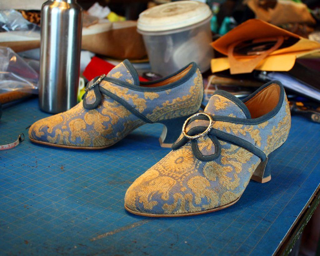 a pair of custom blue & yellow heels shoes
