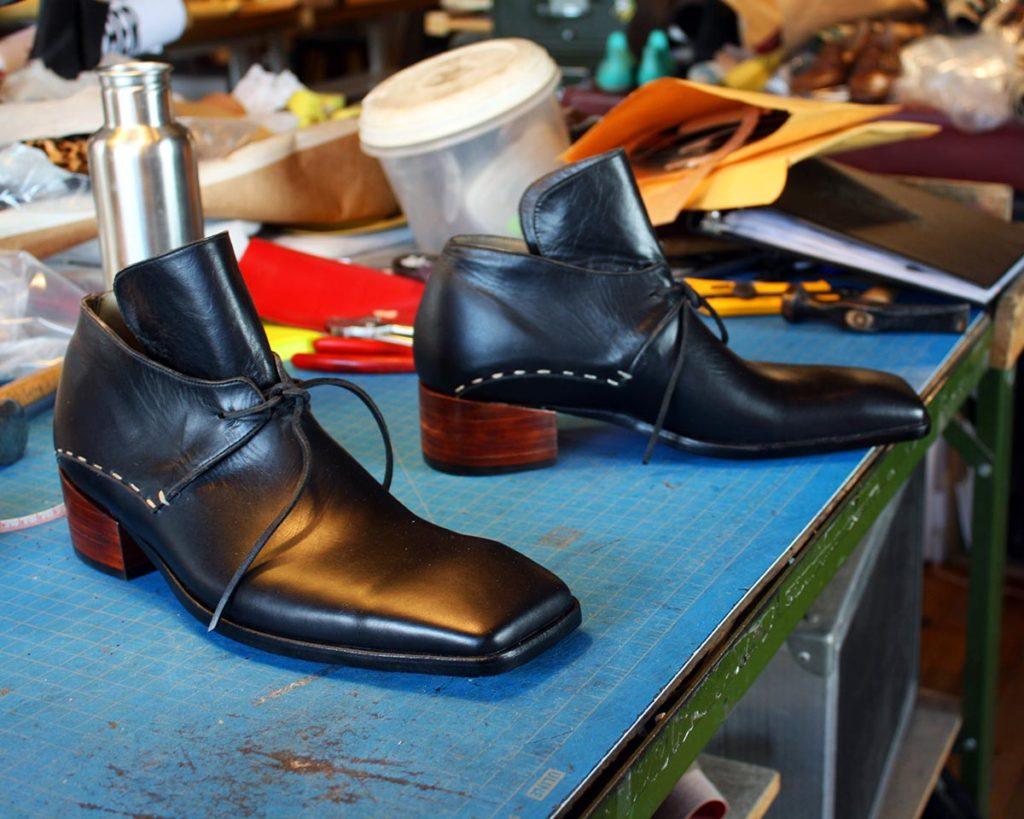 a pair of custom black leather shoes