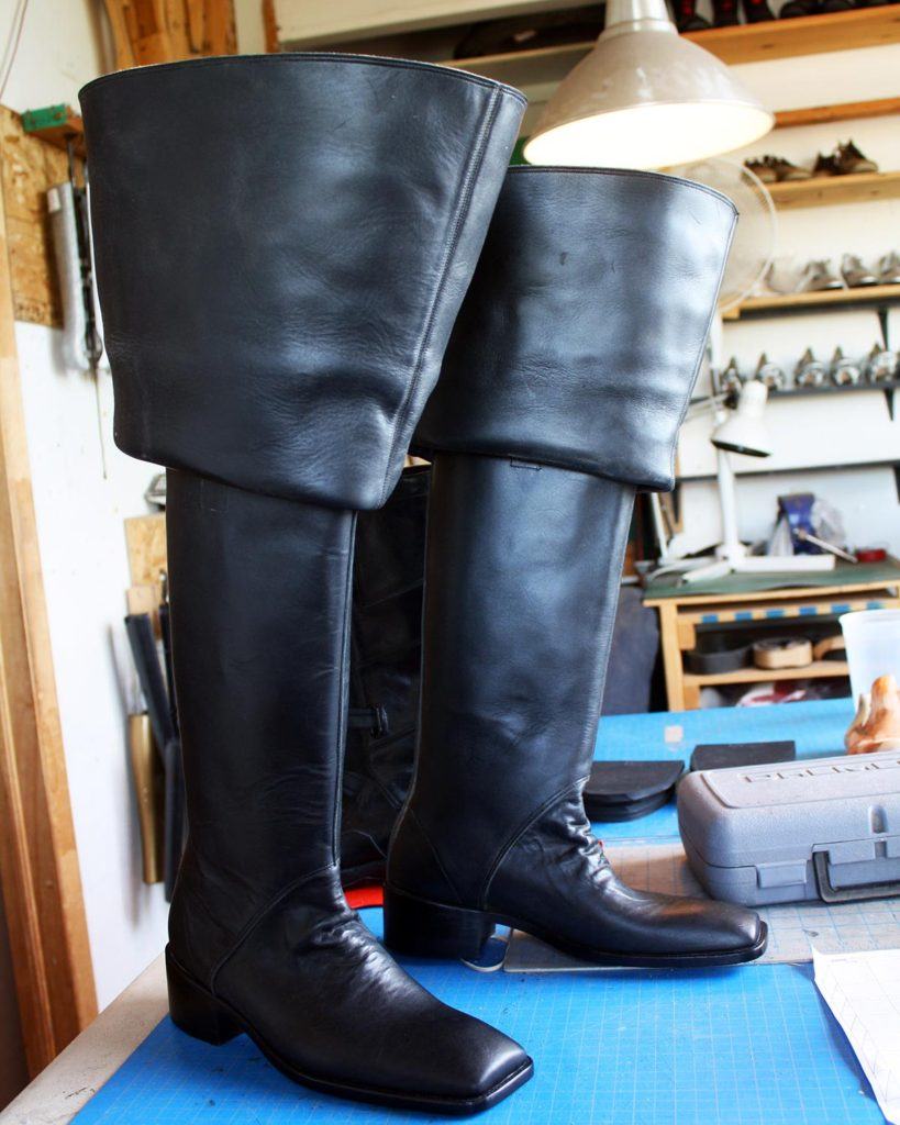 a pair of custom black theatre period boots