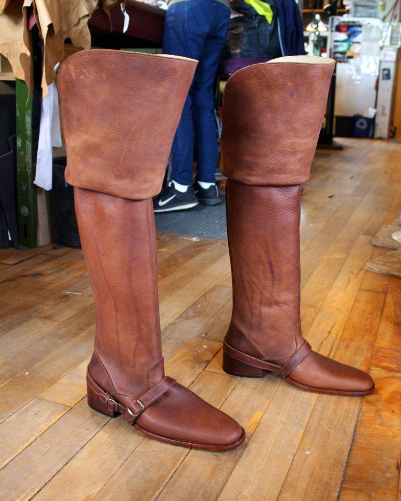 a pair of custom brown period theatre boots with strap