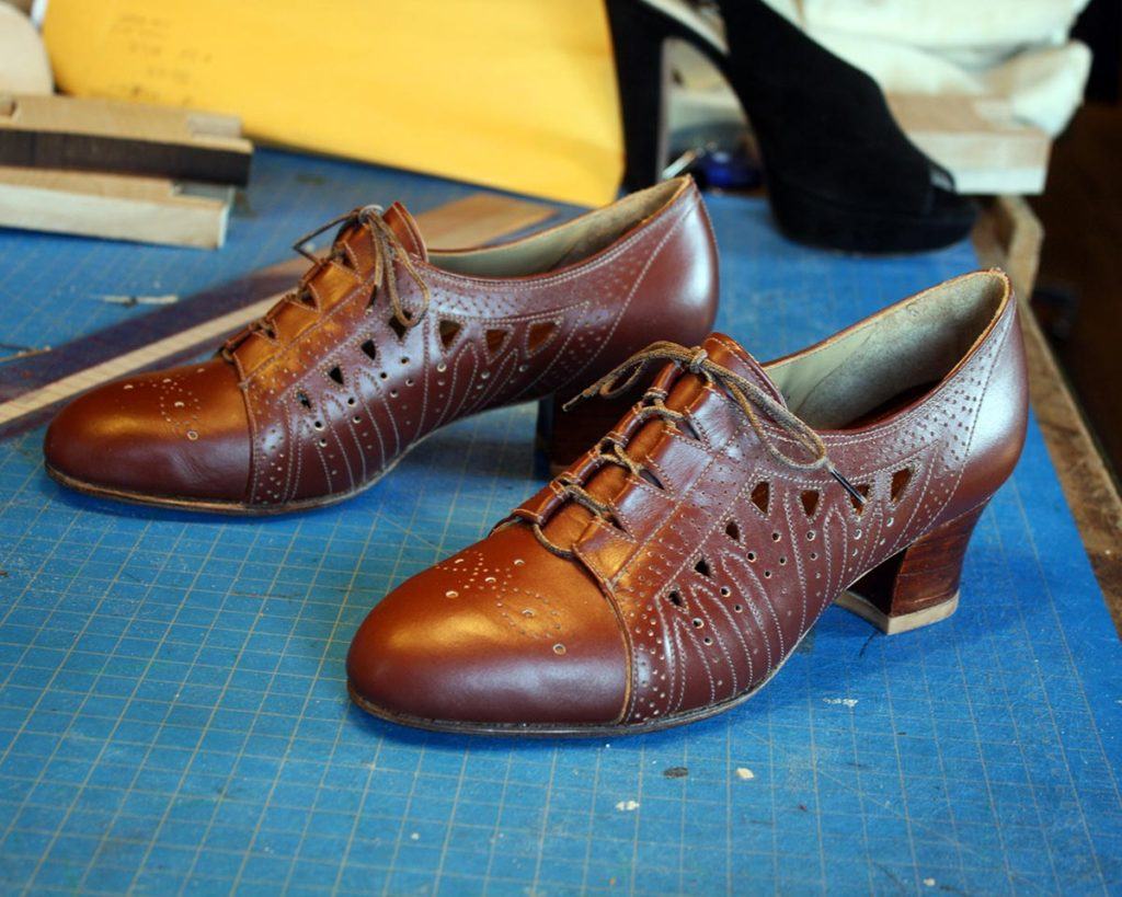 a pair of custom brown fancy shoes with heels