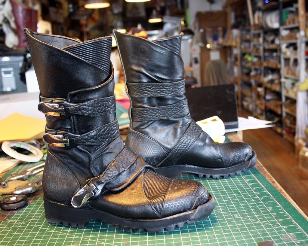 a pair of custom black boots with strap