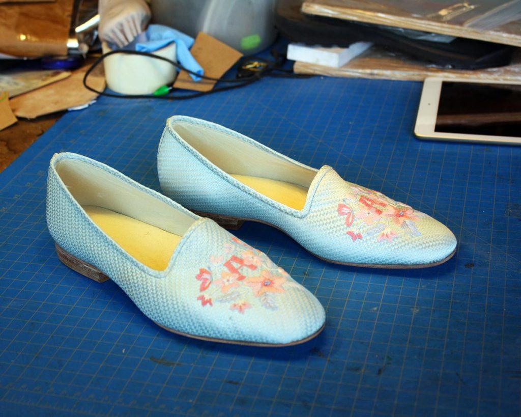 a pair of custom white shoes with embroidery
