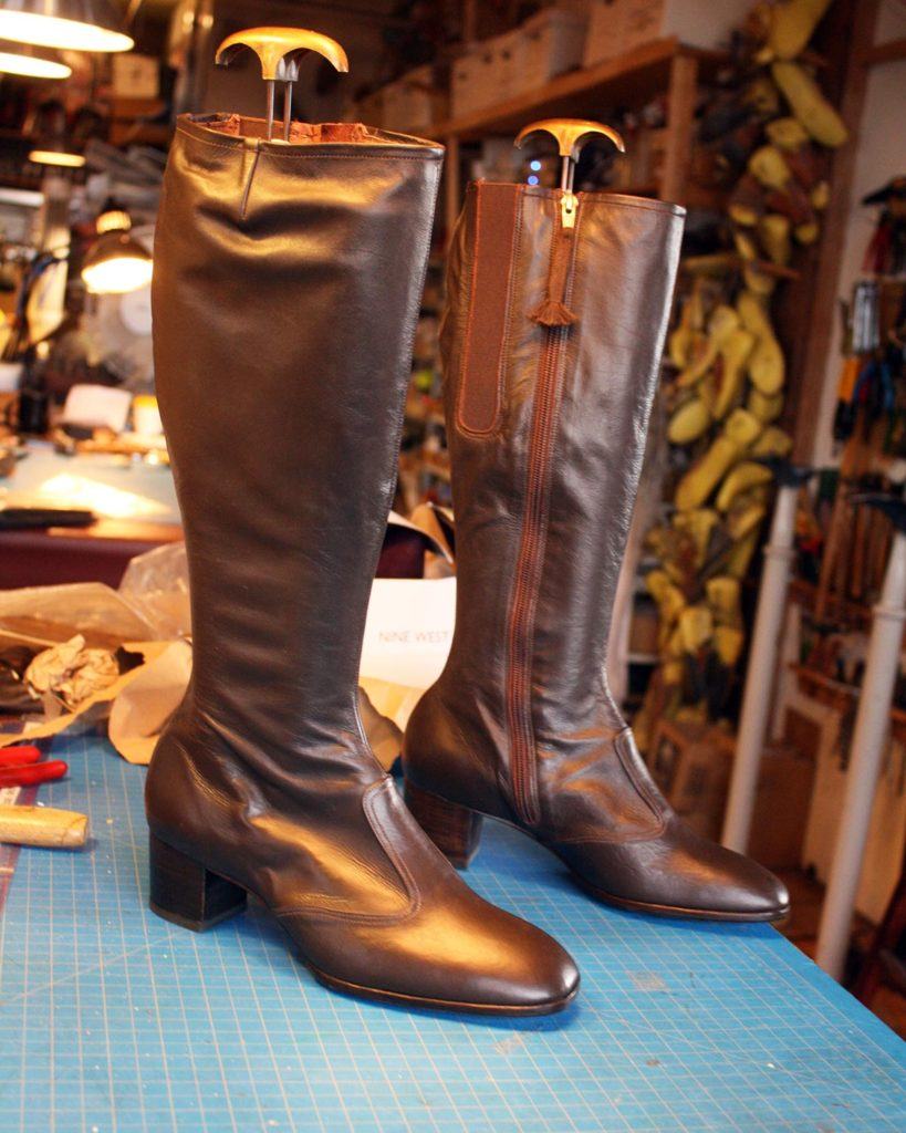 a pair of custom brown leather booths with zip