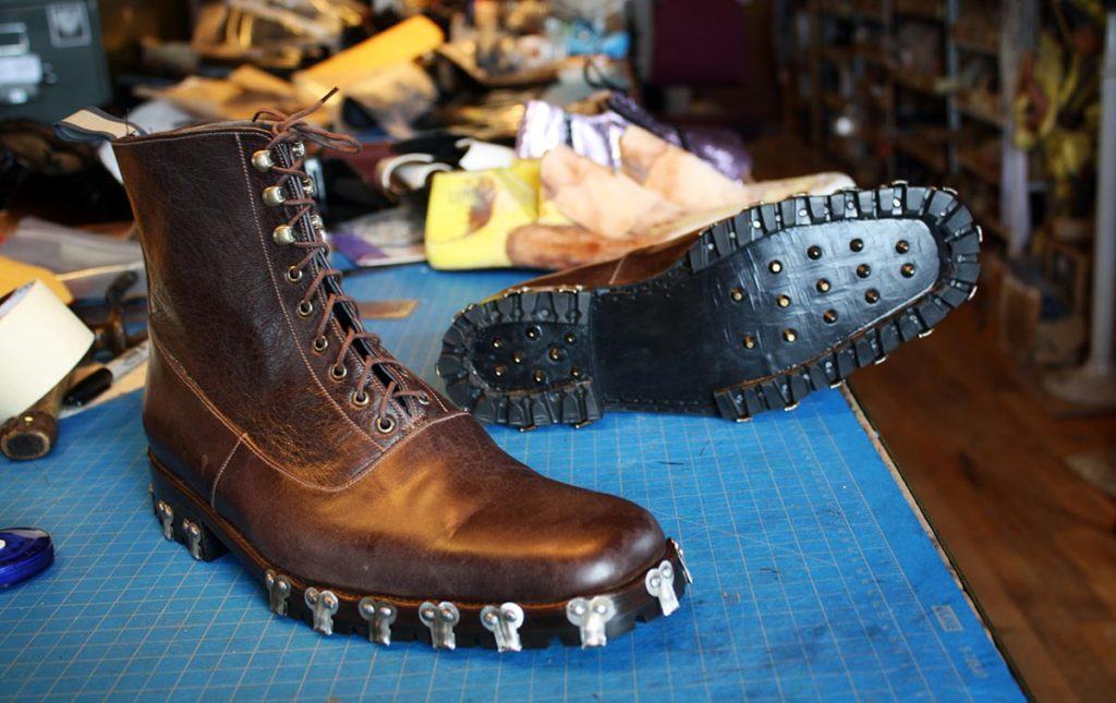 a pair of custom brown boots with spikes
