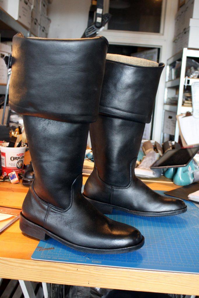a pair of custom period black lather boots