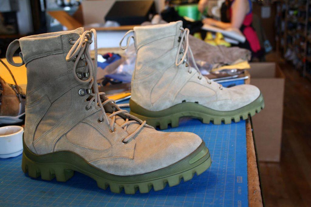 a pair of custom grey & green boots