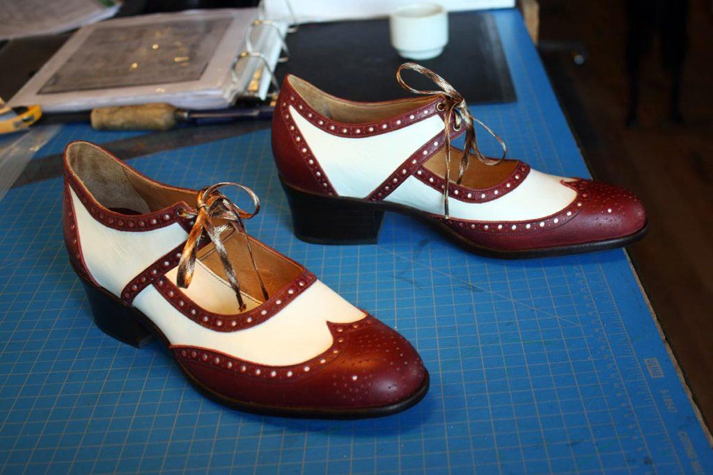 a pair of brown & white valley shoes with heel