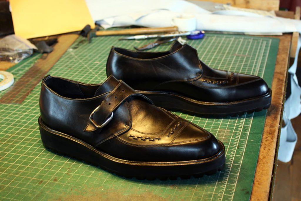 pair of black leather shoes with buckle