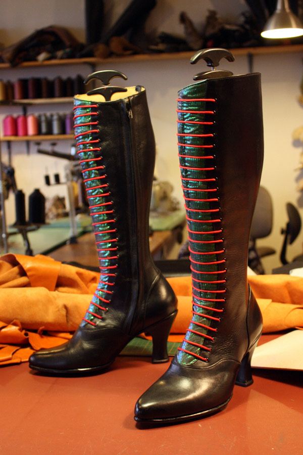 black and green knee length boots with red laces