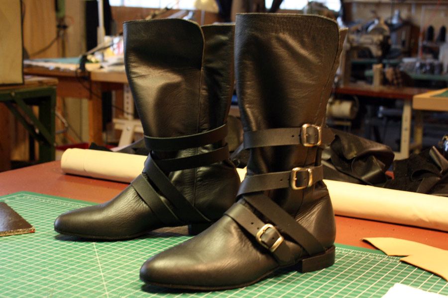 black boots with three straps with buckles